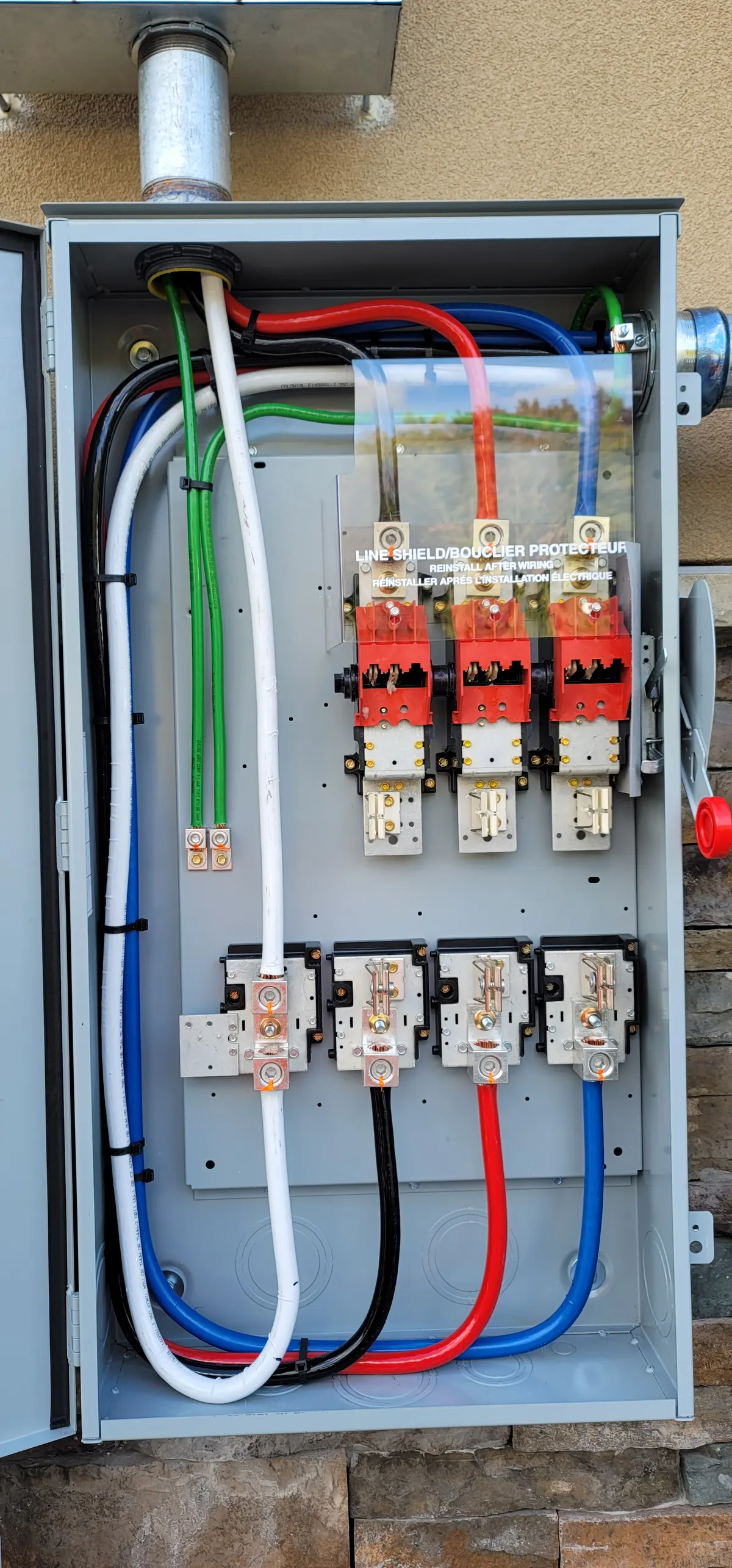 Solar AC disconnect with line shield and color-coded cable management