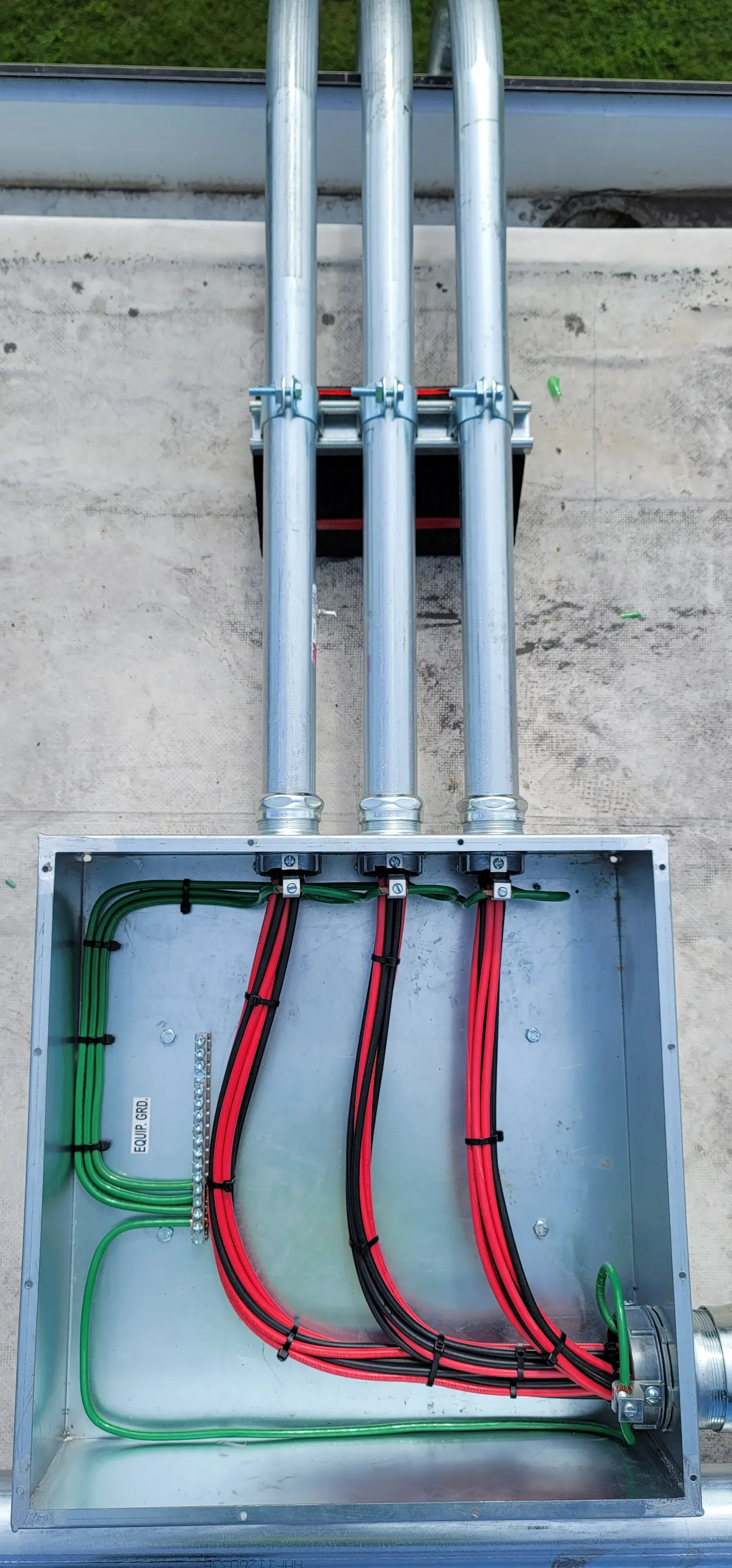 Solar DC junction box with conduit and neatly routed conductors