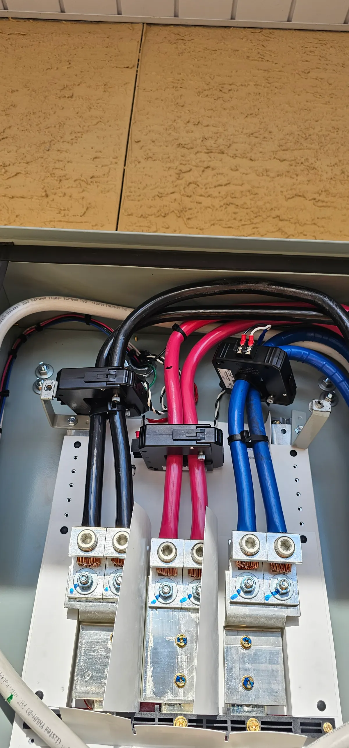 Solar feeder cables terminated cleanly on disconnect lugs with current transformers