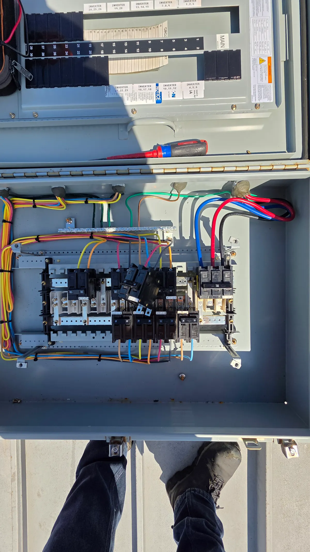 Solar inverter combiner panel with labeled inverter circuits and breakers