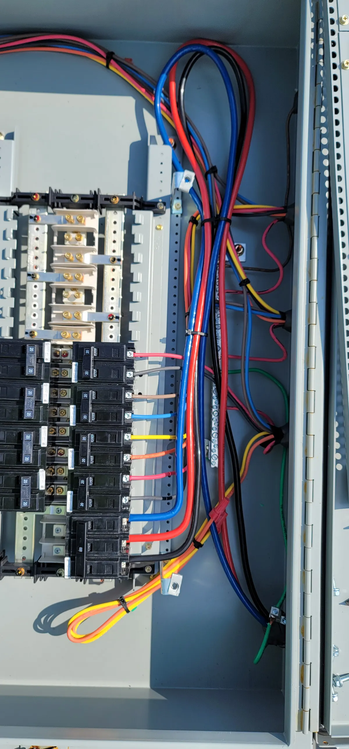 Solar panelboard with breakers and color-coded conductors neatly organized